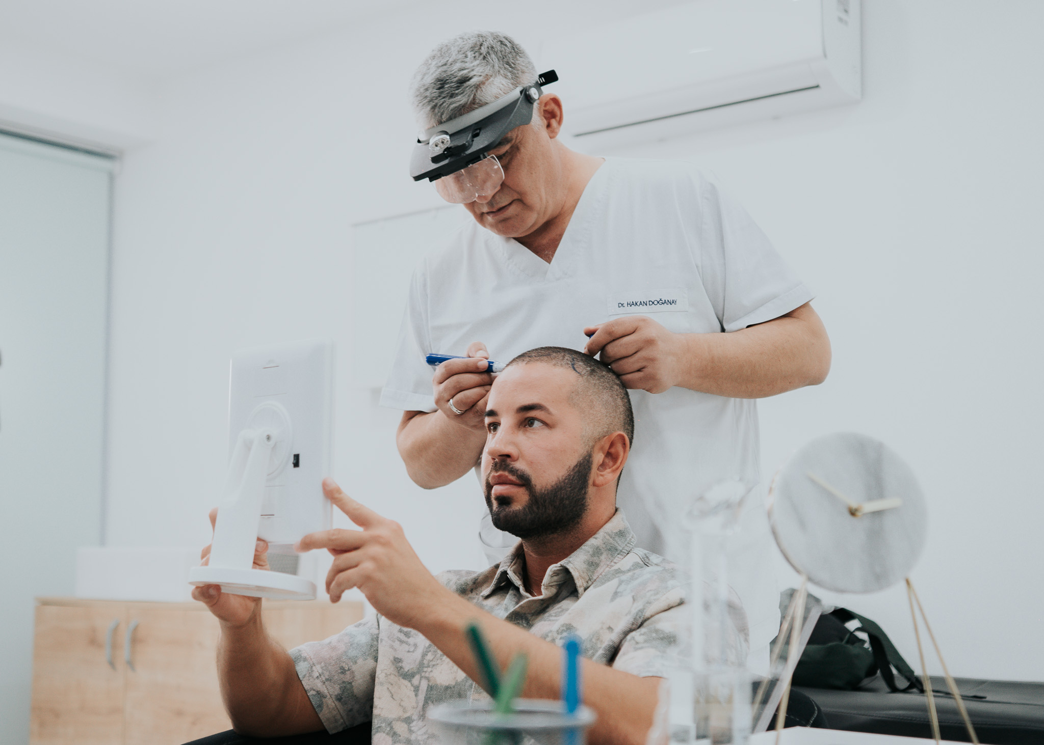 Dr. Hakan Doğanay marking a patient's hairline during pre-operation planning